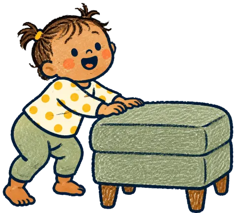 A baby pulling up to stand against a footstool.