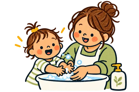A parent and a toddler washing hands together.